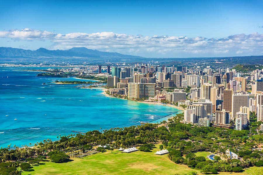 Honolulu, HI Insurance - Aerial View of the City of Honolulu, Hawaii on a Bright Sunny Day, Water to the Left and Cityscape to the Right